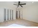 Bright bedroom with a ceiling fan, closet, and a doorway at 8525 E Via De Los Libros --, Scottsdale, AZ 85258