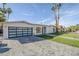 Modern exterior with a glass garage door, landscaped yard and block driveway at 8525 E Via De Los Libros --, Scottsdale, AZ 85258