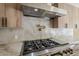 Modern kitchen featuring stone countertops, updated appliances, and a stainless steel range hood at 8525 E Via De Los Libros --, Scottsdale, AZ 85258