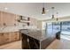 Large open kitchen with a large marble island, stainless appliances and wood cabinets at 8525 E Via De Los Libros --, Scottsdale, AZ 85258