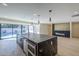 Open kitchen with a large center island, modern appliances, and bright lighting at 8525 E Via De Los Libros --, Scottsdale, AZ 85258