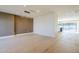 Open living space with hardwood floors and a glimpse of the modern kitchen and pool area at 8525 E Via De Los Libros --, Scottsdale, AZ 85258