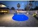 Backyard with a stunning pool, modern patio, outdoor kitchen, and view of the home's contemporary design at 8525 E Via De Los Libros --, Scottsdale, AZ 85258