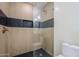 Modern bathroom shower with glass door, tiled walls, and a black tiled floor at 8525 E Via De Los Libros --, Scottsdale, AZ 85258