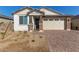 New construction home with stone accents and a two-car garage at 12245 S 172Nd Ave, Goodyear, AZ 85338