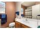 Bathroom with wood vanity and striped shower curtain at 14533 N 147Th Dr, Surprise, AZ 85379