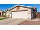 One-story house with a two-car garage and desert landscaping at 14533 N 147Th Dr, Surprise, AZ 85379