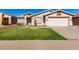 One-story house with a two-car garage and well-manicured lawn at 14533 N 147Th Dr, Surprise, AZ 85379