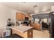 Well-equipped kitchen featuring wood cabinets and a breakfast bar at 14533 N 147Th Dr, Surprise, AZ 85379