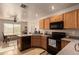 Functional kitchen with black appliances and wood cabinets at 14533 N 147Th Dr, Surprise, AZ 85379