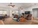 Spacious living room with two ceiling fans and large TV at 14533 N 147Th Dr, Surprise, AZ 85379