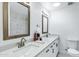 Bathroom with double vanity, modern lighting, and tiled walls at 1521 E Del Rio Dr, Tempe, AZ 85282
