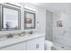 Bright bathroom featuring dual sinks, quartz countertops, and marble tiled shower at 1521 E Del Rio Dr, Tempe, AZ 85282
