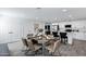 A dining room with a table set for six, connecting to a modern kitchen, perfect for gatherings at 1521 E Del Rio Dr, Tempe, AZ 85282