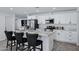 Stylish kitchen boasts white cabinets, stainless appliances, and a central island with comfortable seating at 1521 E Del Rio Dr, Tempe, AZ 85282