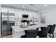 This is a kitchen with white cabinets, stainless steel appliances, and a center island with bar seating at 1521 E Del Rio Dr, Tempe, AZ 85282