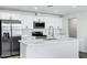 Modern white kitchen with stainless steel appliances and quartz countertops at 1521 E Del Rio Dr, Tempe, AZ 85282