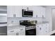 Modern kitchen features stainless steel appliances, white cabinets, and quartz countertops at 1521 E Del Rio Dr, Tempe, AZ 85282