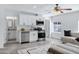 Bright living space featuring stainless appliances, white cabinetry, and ceiling fan at 1521 E Del Rio Dr, Tempe, AZ 85282