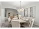 Elegant dining room showcasing a round table, six chairs, and a contemporary chandelier at 1651 E Redwood Pl, Chandler, AZ 85286