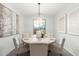 Bright dining room with round table and seating for six, featuring modern light fixture at 1651 E Redwood Pl, Chandler, AZ 85286