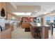 Open kitchen with island, double sink, and a view to the dining area at 19402 N Willow Creek Cir, Sun City, AZ 85373