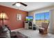 Relaxing living room with golf course views and a comfortable rocking chair at 19402 N Willow Creek Cir, Sun City, AZ 85373