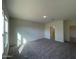 Bright bedroom with carpet flooring and access to bathroom at 2113 E Bucking Bronco Dr, San Tan Valley, AZ 85140