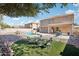 Relaxing backyard with pool, patio furniture, and rock landscaping at 22194 N Kingston Dr, Maricopa, AZ 85138
