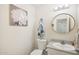 Clean bathroom with a vanity, toilet, and large round mirror at 22194 N Kingston Dr, Maricopa, AZ 85138