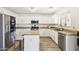 Modern kitchen with white cabinets, granite countertops and stainless steel appliances at 22194 N Kingston Dr, Maricopa, AZ 85138