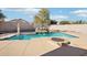Inviting backyard pool with waterfall feature and fire pit at 22194 N Kingston Dr, Maricopa, AZ 85138