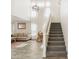 Bright entryway with staircase, and view into living room at 22194 N Kingston Dr, Maricopa, AZ 85138