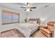 Cozy bedroom with a comfy chair and ceiling fan at 222 E Saint John Rd, Phoenix, AZ 85022