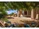 Relaxing backyard patio with seating area, outdoor kitchen, and shade trees at 26807 N 56Th St, Scottsdale, AZ 85266