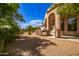 Outdoor kitchen and patio area with seating, statues, and shade trees at 26807 N 56Th St, Scottsdale, AZ 85266