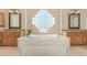 Elegant bathroom with soaking tub, double vanities, and glass block window at 26807 N 56Th St, Scottsdale, AZ 85266