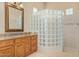 Modern bathroom with glass shower, granite countertop and wood cabinets at 26807 N 56Th St, Scottsdale, AZ 85266