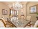 Elegant dining room features a chandelier and glass-top table at 26807 N 56Th St, Scottsdale, AZ 85266