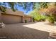 Three-car garage with brick driveway and landscaping at 26807 N 56Th St, Scottsdale, AZ 85266
