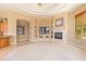 Living room with fireplace, built-in shelving, and large windows at 26807 N 56Th St, Scottsdale, AZ 85266