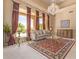 Living room with ornate rug, chandelier and large windows at 26807 N 56Th St, Scottsdale, AZ 85266