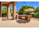 Covered patio with outdoor kitchen and pizza oven at 26807 N 56Th St, Scottsdale, AZ 85266