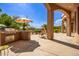 Outdoor kitchen area with grill, pizza oven, and seating at 26807 N 56Th St, Scottsdale, AZ 85266