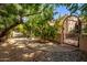 Landscaped walkway leading to ornate iron gate at 26807 N 56Th St, Scottsdale, AZ 85266