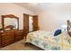 Bright bedroom with wooden dresser and floral bedding at 28626 N 108Th N Way, Scottsdale, AZ 85262
