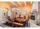 Large dining room with a stunning wood table and fireplace at 28626 N 108Th N Way, Scottsdale, AZ 85262