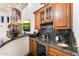 Home bar with granite counters, wine storage, and copper sink at 28626 N 108Th N Way, Scottsdale, AZ 85262