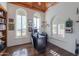 Bright home office features built-in shelving, wood ceiling, and large windows at 3816 E Minton Pl, Mesa, AZ 85215