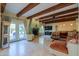 Spacious living room with exposed beams and a fireplace at 3816 E Minton Pl, Mesa, AZ 85215